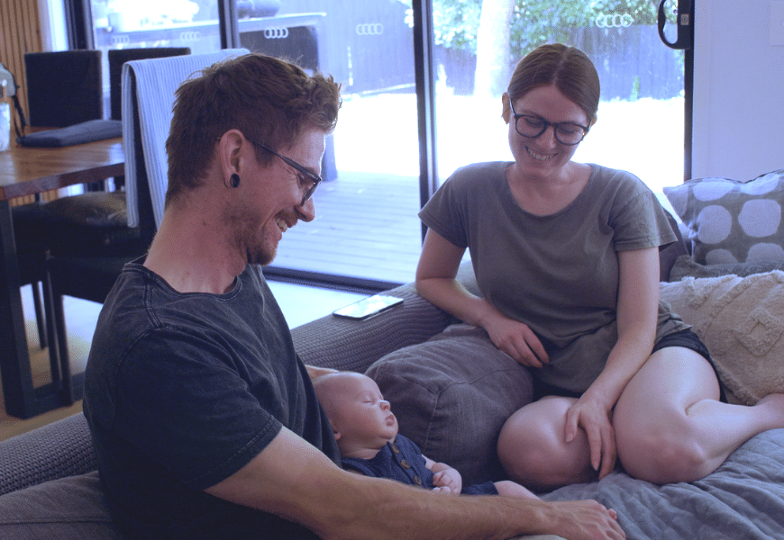 Mike, Max and Sinead Redding sitting on the couch at their home in Victoria