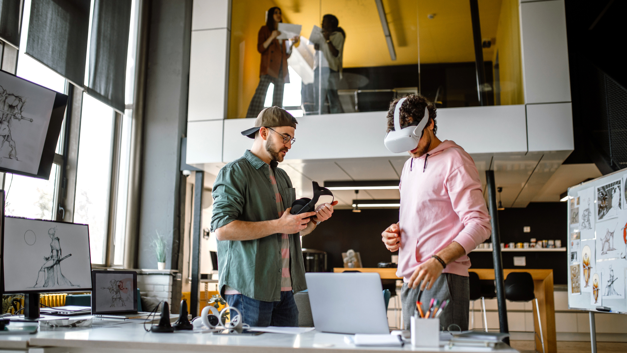 Group of colleagues in an office using virtual reality simulator headsets.