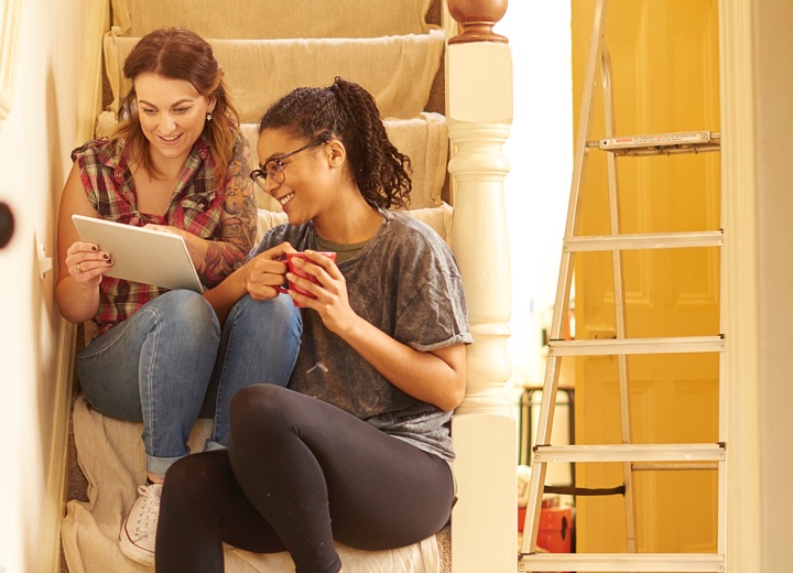 Female couple looking at tablet.