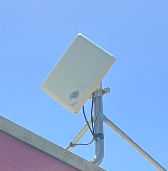 Old wntd outdoor unit attached to a roof.